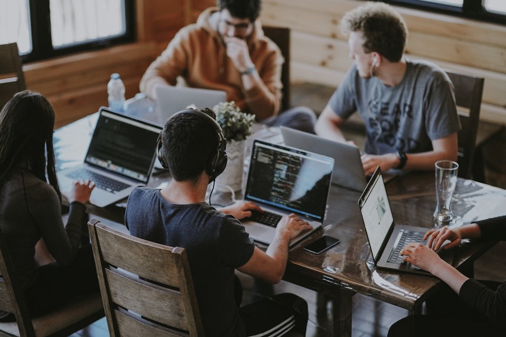 Developers collaborating on code and data projects around a shared table